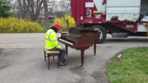 Bin collector plays piano outside house collection item